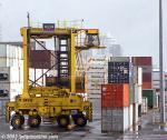 ID 1868 PORT OF AUCKLAND, NZ - A straddle carrier manoeuvring among container stacks, Axis Fergusson Container Terminal.